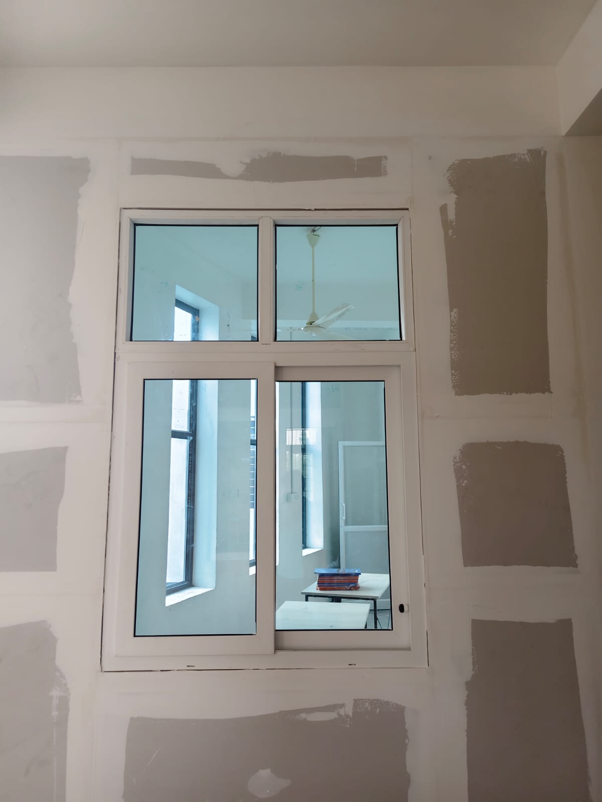 uPVC sliding window installation for a villa project in Coimbatore by MG Windows and Doors